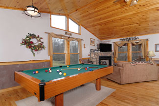 Pigeon Forge One Bedroom Cabin that features a pool table and a flat screen tv in the living room